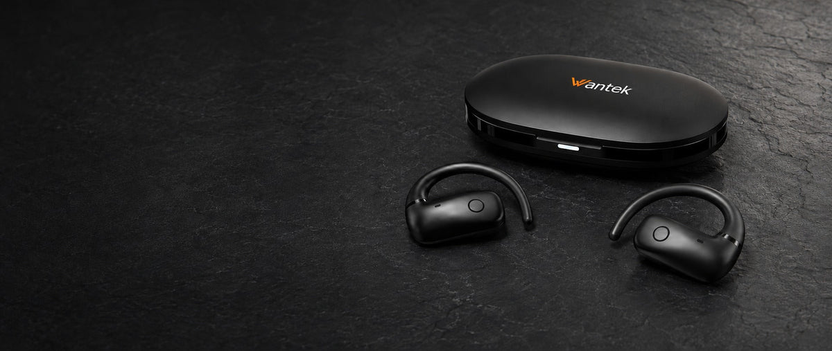 Black Wantek open-ear earbuds beside their charging case on a dark tabletop