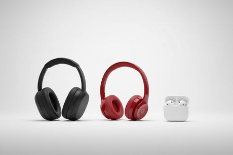 Black and red wireless over-ear headphones and white wireless earbuds with charging case on white background