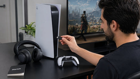 Bluetooth headphones and USB audio transmitter beside a PS5 for wireless audio setup
