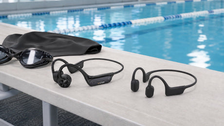 Wantek BC3 Pro and Shokz OpenSwim Pro bone-conduction headphones beside a swimming pool