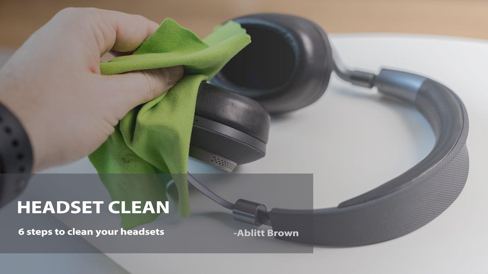 Person cleaning black wired headset with green cloth on white surface, Wantek brand focus