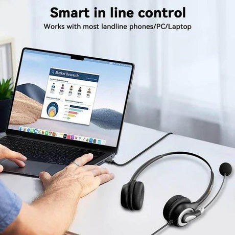 Person using laptop connected to a black Wantek wired headset with inline control on a white desk